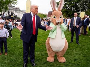 President Donald Trump stands with the Easter bunny as he participates in the White House Easter Egg Roll