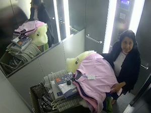 Supporting image for story: CCTV images show 'industrial scale' shoplifter taking clothes as part of huge shops fraud