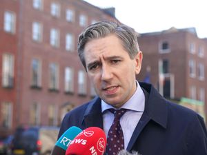 Irish deputy premier Simon Harris speaks to the media