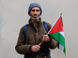 A man holding a Palestinian flag