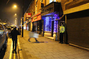 A police officer stand outside an address in Hagley Road, Birmingham, where armed police have raided a flat overnight