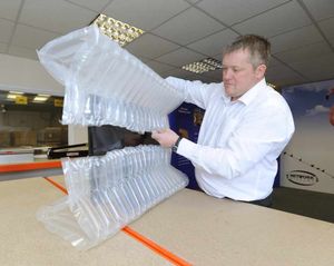 Carl Smethurst testing packaging on a television at Network Packaging