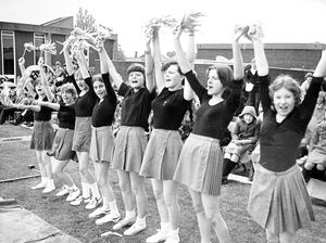 Picture caption: 'Oldbury School at Bridgnorth held an It's A Knockout competition. Teachers also took part.' the picture shows cheerleaders in action on 8 July 1980.