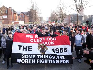 Manchester United fan group The 1958 march behind a banner reading 'We want our club back - some things are worth fighting for' as they protest against the club's ownership ahead of the Premier League match against Arsenal