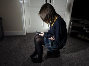 Child sitting with a mobile phone