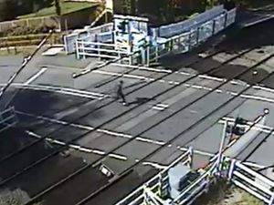 Supporting image for story: WATCH: Terrifying moment youngster sprints across level crossing