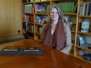 Dr Jessica Gardner with the two Darwin manuscripts which have been anonymously returned to Cambridge University Library. Photo: Cambridge University Library/PA Wire