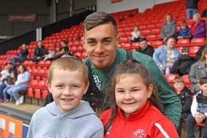 Taylor Allen poses with two young fans.