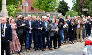 Mourners applaud as the cortege passes