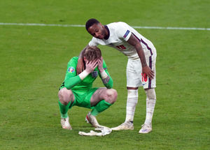 England goalkeeper Jordan Pickford stands dejected with Raheem Sterling (right)