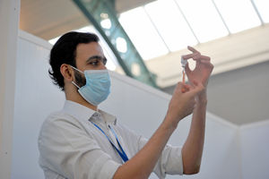 Pharmacist Syed Anas Gilani gets set to give a vaccine