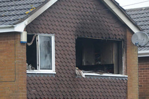 The blackened interior can be seen through the blown-out window