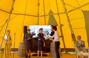 Tracey Lockley from Mobell, left, with an RAF cadet, Professor Liz Barnes - the Lord Lieutenant of Staffordshire, presenting the King's Award to Takeshi Yoshida, with chairman Vince Owen, seated right.