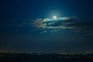 A supermoon or blue moon appears over the city lights of Birmingham in January 2018. Photo: Peter Lopeman/Alamy Live News