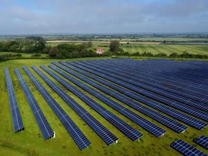 Aerial view of a solar farm in a field
