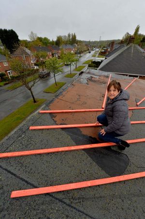 Sue Bate on the damaged roof last year
