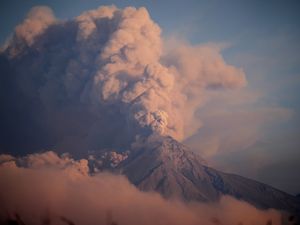 The Volcan de Fuego, or Volcano of Fire, blows a thick cloud of ash seen from Palin, Guatemala