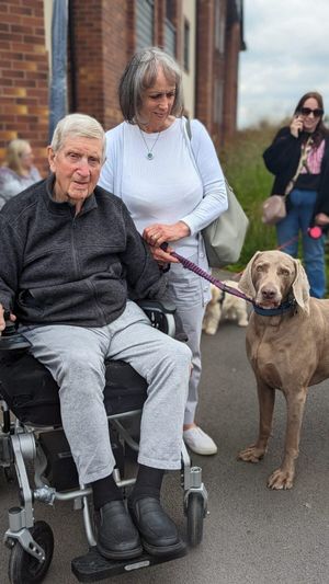 Resident, Roger Roberts, with a visiting four-pawed friend. Photo: Ideal Carehomes