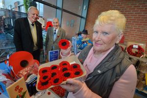 Eve Jones with her knitted poppies, and pictured behind are Mike Souttar, Colin Cole and Roger Whitting