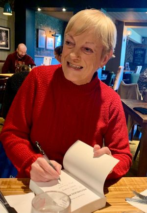 Liz signing one of her books