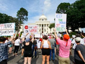 Protesters for women’s rights hold a rally on the Alabama Capitol steps in Montgomery to protest the law making abortion a crime in nearly all cases
