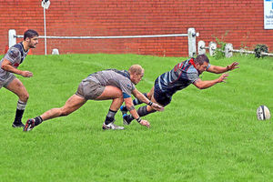 Stefan Shillingford dives to score a try for DK Pic: Ian Jackson