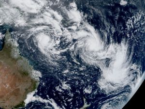 A satellite image showing three cyclones east of Australia