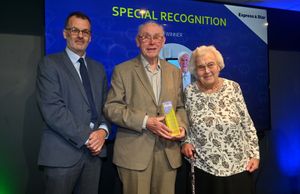   Mark Drew presents the Special Recognition Award sponsored by the Express & Star to Eric and Brenda Moore from the YMCA Black Country Group,