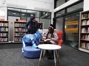 Supporting image for story: Queen praises community resilience as library torched during riots reopens