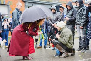 The Princess of Wales shelters from rain under a umbrella whilst meeting members of the public during a visit to the Hanging Gardens. Photo: Ben Birchall/PA Wire