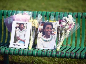 Flowers and pictures left at a vigil on Danes Drive Park in Glasgow for Eritrean refugee Amen Teklay