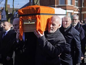 Former Sinn Fein president Gerry Adams (right) walks behind the coffin of Brendan ‘Bik’ McFarlane as it leaves his family home on Cliftonville Road, Belfast