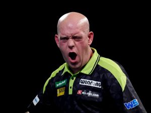 Supporting image for story: Michael van Gerwen survives scare to reach World Championship second round