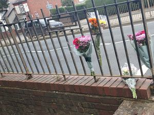 Floral tributes were left on a set of railings on Thorns Road where Miss Rafique was killed