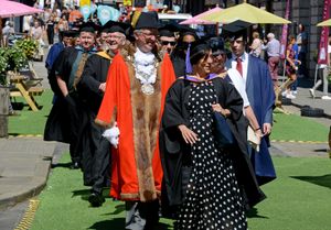 Tutors proudly march through the town 