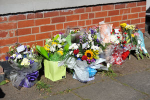 Flowers and messages outside the property