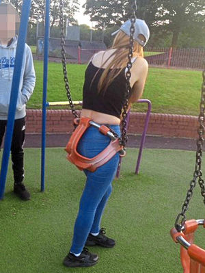 A 14-year-old girl stuck in a child's swing had to be rescued by firefighters