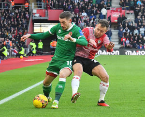 Walsall's Tom Knowles holds off Southampton's Ryan Fraser