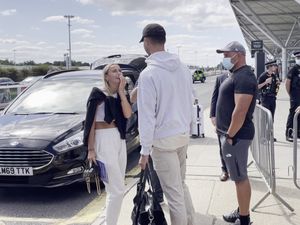 Supporting image for story: Love Island winners Millie and Liam share kiss as they touch down in UK