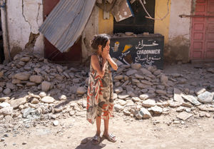 A child reacts after inspecting the damage caused by the earthquake, in her town of Amizmiz, near Marrakech, Morocco