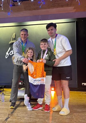 Tom & Josh being presented with a signed MND running vest to celebrate their achievement.