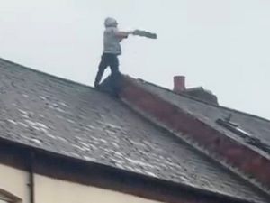 Supporting image for story: Shock moment man in Birmingham launches roof tiles to the ground during standoff with police