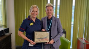 Lisa Davies-Jones, Pre-Operative Assessment Unit Manager, receiving the Sam Young Innovation and Improvement Award from Stacey Keegan, Chief Executive.