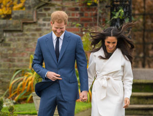 The happy couple share a laugh on their way to posing for photographs