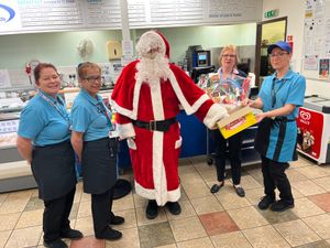 Cafe staff join Father Christmas to draw the winning ticket
