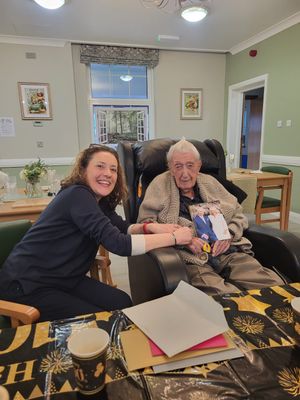 Maurice receiving his telegram from the King, with daughter Fiona 
