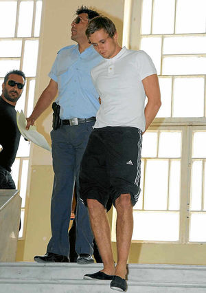 Luke is escorted by police as he leaves the court