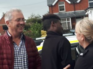 The migrant being led away by officers