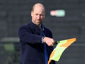 The Prince of Wales waving a linesman's flag