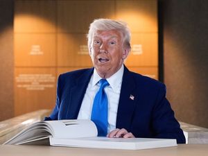 President Donald Trump signs a guest book